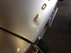 Before paintless dent repair on a Porsche rear panel showing visible dent damage in Fife Lake, Michigan