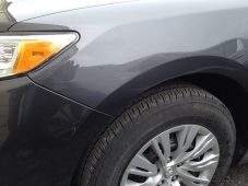 Front fender dent above the wheel fully repaired after paintless dent repair