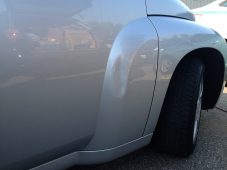 hevy HHR front fender dent before paintless dent repair at Collins Dent Werks in Fife Lake Michigan