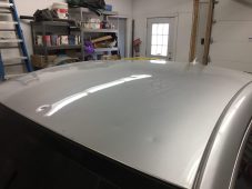 Vehicle roof showing hail dent damage before paintless dent repair at Collins Dent Werks in Fife Lake, Michigan
