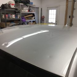 Vehicle roof showing hail dent damage before paintless dent repair at Collins Dent Werks in Fife Lake, Michigan