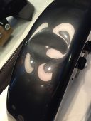 Dented Harley-Davidson motorcycle fender before paintless dent repair at Collins Dent Werks in Fife Lake, Michigan