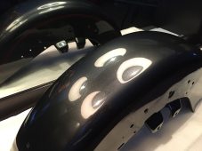 Dented Harley-Davidson motorcycle fender before paintless dent repair at Collins Dent Werks in Fife Lake, Michigan