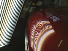 Finished paintless dent repair on a Harley-Davidson motorcycle fuel tank at Collins Dent Werks in Fife Lake, Michigan