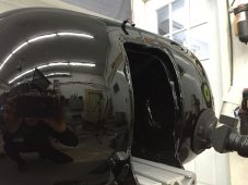 Completed paintless dent repair on a Harley-Davidson motorcycle fuel tank at Collins Dent Werks in Fife Lake, Michigan
