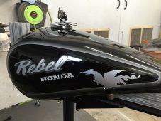 Honda Rebel motorcycle fuel tank dent before paintless dent repair at Collins Dent Werks in Fife Lake, Michigan