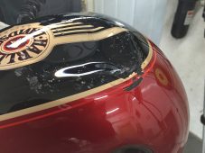 Harley-Davidson motorcycle fuel tank dent before repair at Collins Dent Werks in Fife Lake, Michigan