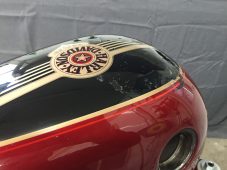 Harley-Davidson motorcycle fuel tank dent before repair at Collins Dent Werks in Fife Lake, Michigan