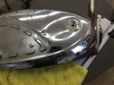 Motorcycle fuel tank dent repair in progress at Collins Dent Werks in Fife Lake, Michigan