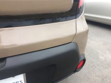 After photo of a Kia rear panel following paintless dent repair, showing a smooth surface and factory body lines.