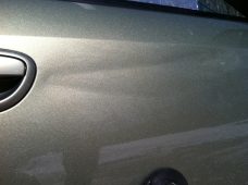 Subaru Door Crease Before Paintless Dent Repair | Collins Dent Werks